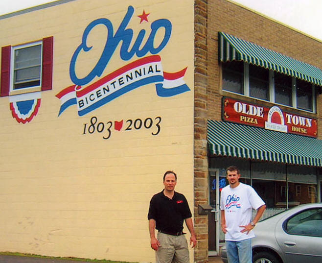 Ohio's official Bicentennial logo painted on the side of the Olde Town Pizza House building, 1803–2003