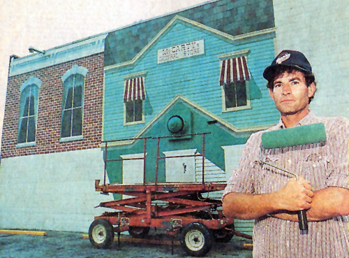 Morning Journal newspaper photo of artist David Pavlak in front of the mural in progress, 1991